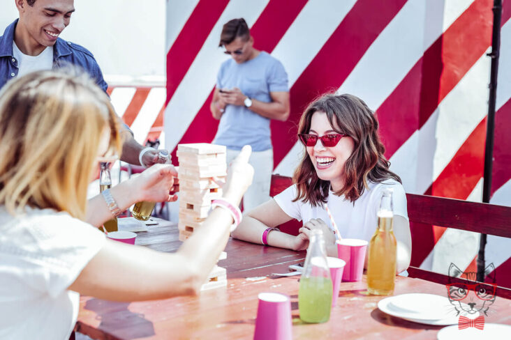 stylish people charming brunette female keeping smile her face while looking jenga game1