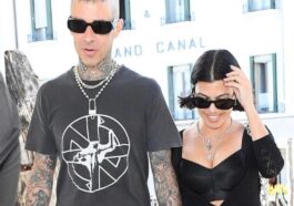 Kourtney Kardashian and Travis Barker pose in bed with matching face masks