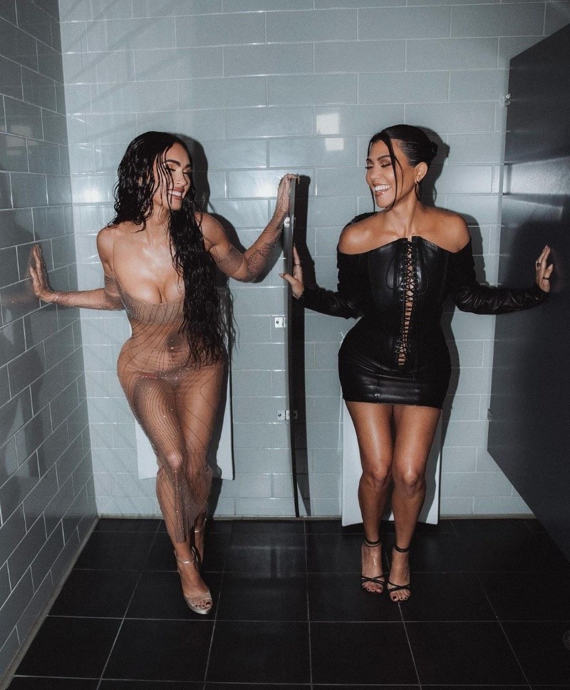 Megan Fox and Kourtney Kardashian pose for Kim Kardashian's new collection in a humorous manner. Megan Fox and Kourtney Kardashian pose for Kim Kardashian's new collection in a humorous manner.