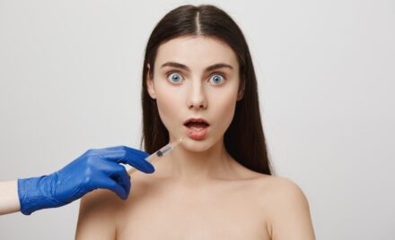 shocked woman open mouth stare worried while take bottox injection lip