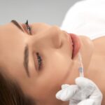 young woman doing lip augmentation salon