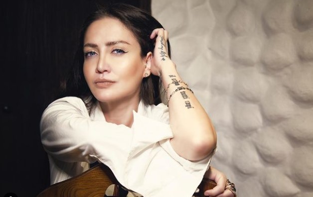 Celia Lora poses in her teddy underwear in the restroom