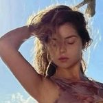 Demi Rose wears a cowboy hat and a sleeveless top as she poses for the camera. Demi Rose Instagram