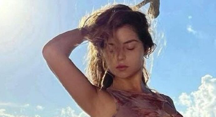 Demi Rose wears a cowboy hat and a sleeveless top as she poses for the camera.