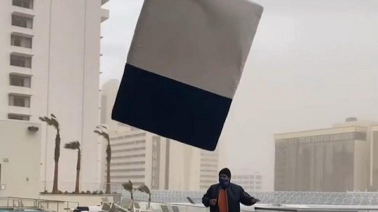Young man records the exact moment in which a flying mattress hits him
