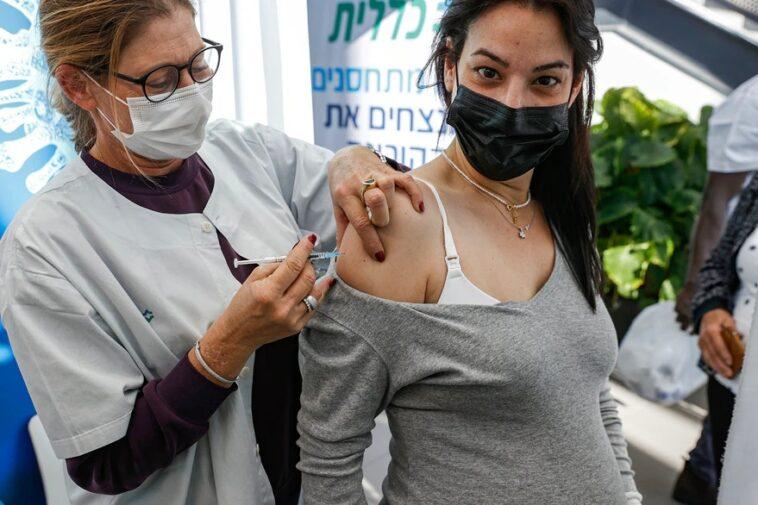 On January 23 2021 At Clalit Health Services In Tel Aviv Israel A Healthcare Professional Gives A Dosage Of The Pfizer Biontech Coronavirus Vaccination To A Pregnant Lady.