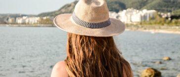 Selective Focus Photography Of Woman Facing Body Of Water