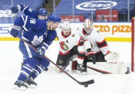 Toronto Maple Leafs TJ Brodie brings the puck around the net before scoring his teams third goal Ottawa Senators during second period NHL hockey action in Toronto Saturday Jan. 1 2022.