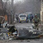 A soldier walks past the wreckage of a military plane that was shot down last night in Kiev.
