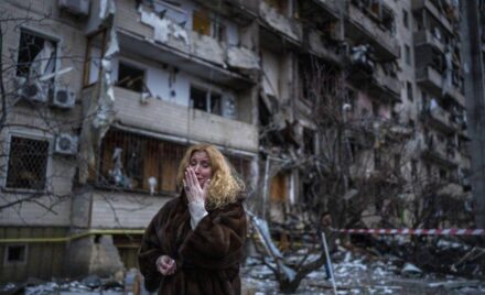 A woman cries next to her house after a bombing in Kiev.