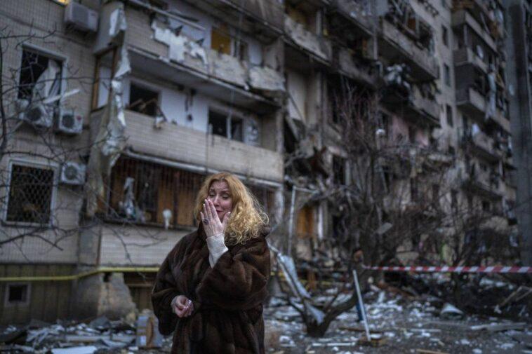 A woman cries next to her house after a bombing in Kiev.