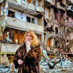 Natali Sevriukova cries outside a building destroyed by Russian rockets in Kiev