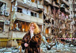 Natali Sevriukova cries outside a building destroyed by Russian rockets in Kiev