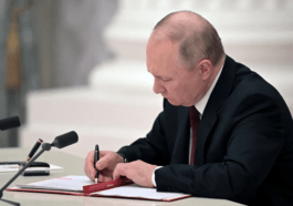 Russian President Vladimir Putin signs documents including a decree recognizing two Russian backed breakaway regions in eastern Ukraine as independent entities