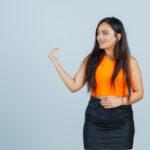 beautiful girl inviting come orange top skirt looking kind front view