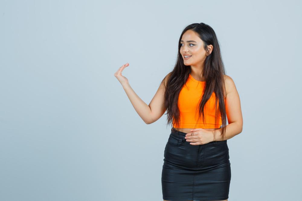 beautiful girl inviting come orange top skirt looking kind front view