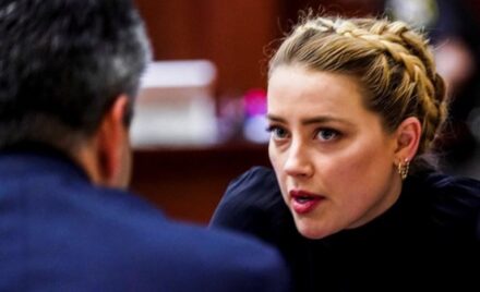 Amber Heard sits with her legal