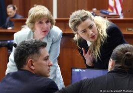 Amber Heard speaks with her legal team as actor Johnny Depp returns to the stand after a lunch break.