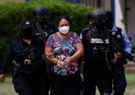 Honduran officials escort Herlinda Bobadilla whose extradition the United States has requested.