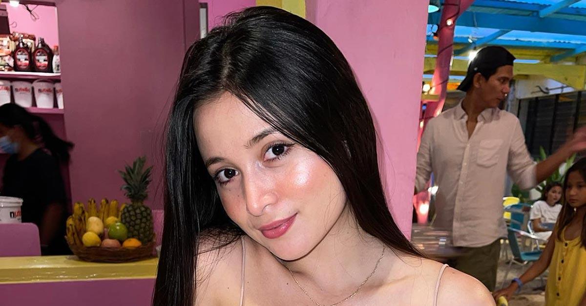 Pandora Kaaki models wearing a translucent robe in her bedroom