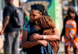 Two women hug before the supermarket this Sunday in Buffalo New York.