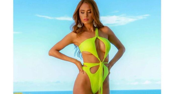 Yanet García poses on her back topless and with a micro-thong that has left nothing to the imagination