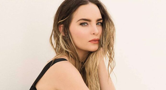 Belinda enters the pool in a sexy bikini, flaunting her small waist and cleavage