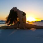 woman wears bikini split on sand dunes at beach