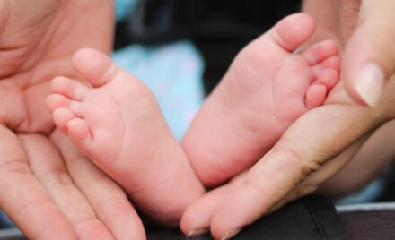 person holding baby feet