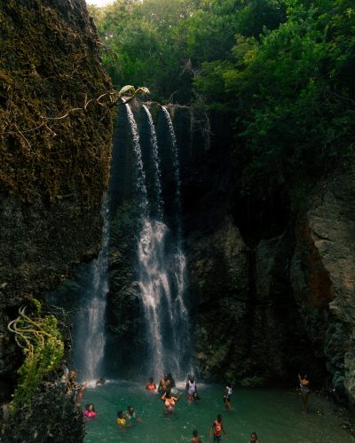 people standing near waterfalls during daytime