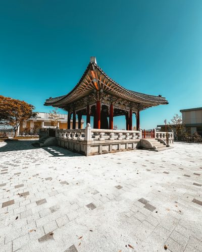 a gazebo sitting on top of a stone walkway